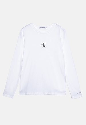 Biała koszulka z długim rękawem wykonana z bawełny, z czarnym logo "ck" na piersi i brandingiem na rękawie. Prosty, klasyczny fason.