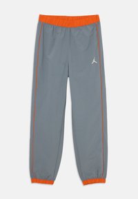 Pantaloni sportivi grigi con elastico in vita e accenti arancioni, dotati di un logo ricamato e strisce laterali a contrasto.