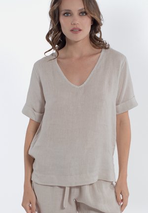 Top in lino a maniche corte di colore beige chiaro con scollatura a V e risvolti, caratterizzato da una vestibilità comoda e da una texture morbida.