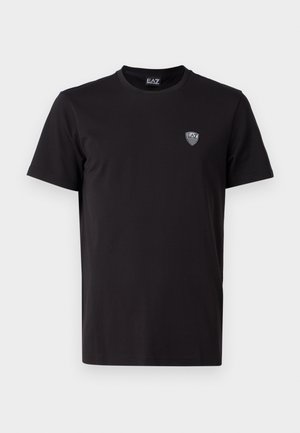 T-shirt nera a maniche corte realizzata in tessuto liscio, con un logo ricamato discreto sul lato sinistro del petto e un classico collo tondo.