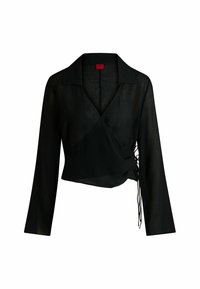 Blouse portefeuille noire texturée avec manches longues, col pointu et liens latéraux ajustables pour un ajustement parfait. Convient pour un style superposé.