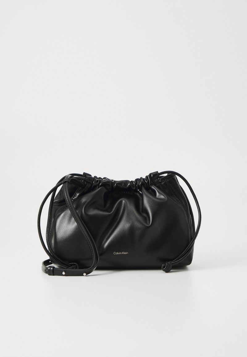 Black leather handbag with gathered design, dual drawstring closure, and detachable shoulder strap. Features metallic logo detail.