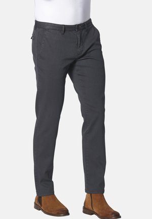 Gray cotton chinos with a slim fit, featuring front pockets, a classic button fly, and subtle stitch detailing, paired with brown ankle boots.