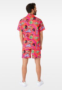 Bright pink short-sleeve shirt and matching shorts featuring a colorful cartoon pattern with various characters and scenes throughout.