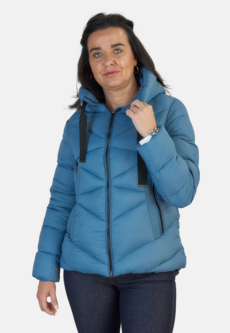 Chaqueta de plumas azul claro con capucha, con cierre frontal de cremallera, acentos de tiras negras y textura de acolchado en chevrón. Diseño casual.