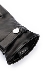 Gant en cuir noir avec une texture lisse, présentant une fermeture à bouton-pression et une doublure intérieure douce. Étiquette à l'intérieur indiquant "ROECKL MÜNCHEN."