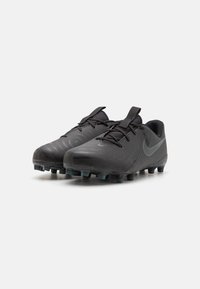 Black soccer cleats with a textured surface, featuring a grey Nike logo, lace-up design, and molded rubber studs for traction.