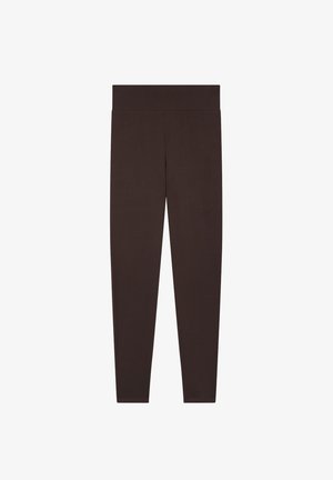 Leggings marroni realizzati in un materiale morbido ed elastico, dotati di una vita ampia e senza cuciture e di un design aderente che si stringe alla caviglia.