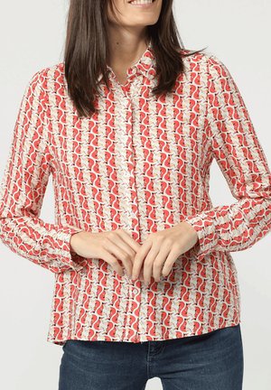 Camisa de cuadros roja y blanca con un patrón de zorros repetido, de mangas largas y con cuello. Confeccionada en tejido ligero con una textura suave.