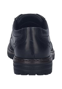 Scarpe in pelle nere con punta arrotondata, parte superiore testurizzata, cuciture dettagliate e suola in gomma spessa. Nessun marchio o accento visibile.