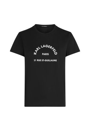 Melna īsroku T-krekls ar baltu tekstu "KARL LAGERFELD" puslokā, zemāk "PARIS" un centrā uz priekšpuses "21 RUE ST-GUILLAUME".