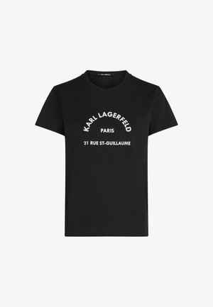 Melna īsroku T-krekls ar baltu tekstu "KARL LAGERFELD" puslokā, zemāk "PARIS" un centrā uz priekšpuses "21 RUE ST-GUILLAUME".