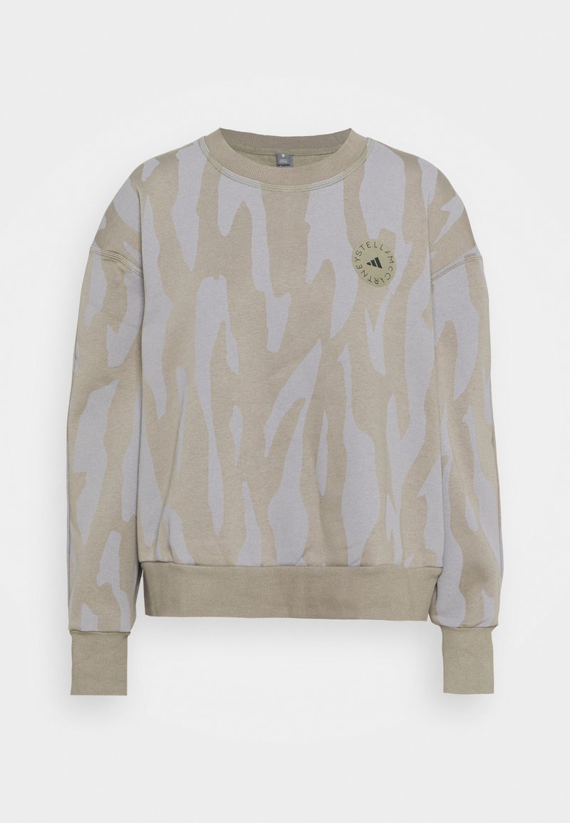 Sweat-shirt long beige et gris clair à motifs, avec poignets et bas côtelés, avec un petit logo circulaire sur la poitrine.