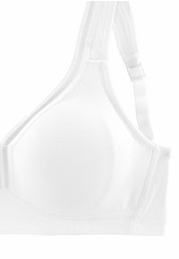 White bra featuring smooth fabric, soft cups, adjustable straps, and elastic trim along the edges. No hooks or clasps visible.