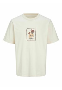 Cremefarvet bomulds t-shirt med korte ærmer og rund halsudskæring. Har et trykt design i en rektangulær ramme på forsiden.