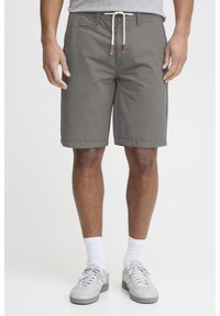 Shorts en coton gris avec une taille à cordon de serrage, des poches latérales et une coupe décontractée. Présente une texture lisse et un ourlet net.
