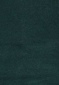 Tessuto a maglia teal con una texture liscia, caratterizzato da un modello a coste uniforme. Nessun hardware o dettaglio visibile.