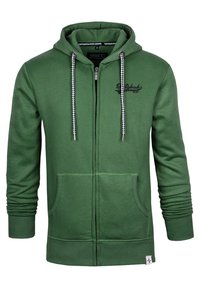 Grüne Zip-Hoodie aus weichem Stoff mit Kapuze mit Kordelzug, Fronttaschen und Kontrastdetails an den Reißverschlüssen und Nähten.