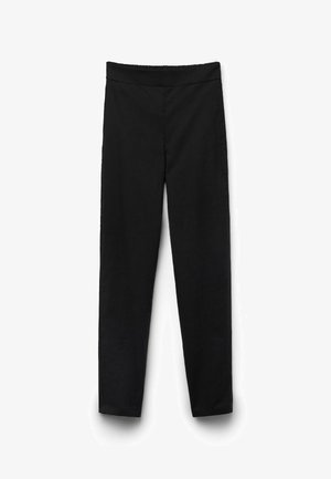 Pantalones negros de corte ajustado con cintura elástica, sin bolsillos visibles ni adornos, mostrados sobre un fondo blanco.