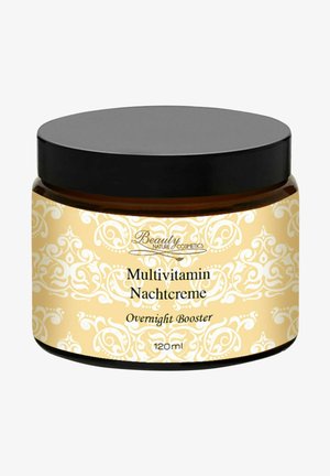 Multivitamin night cream in a 120 ml amber jar with a decorative gold and white pattern and a black lid. Features "Overnight Booster" label.
