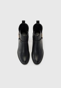 Black leather ankle boots with a smooth finish, rounded toe, low heel, side buckle detail, and pull tab design for easy wear.