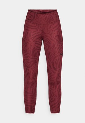 Leggings bordeaux avec un motif abstrait de zèbre. Conception taille haute, matériau extensible et petit logo noir sur le côté gauche.