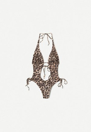 Maillot de bain une pièce imprimé léopard avec un décolleté en V profond, des côtés découpés et des liens ajustables au cou et aux hanches. Texture de tissu lisse.