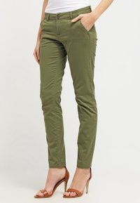 Olive green, tapered chinos made from cotton blend fabric, featuring front pockets, a button closure, and slim fit design.