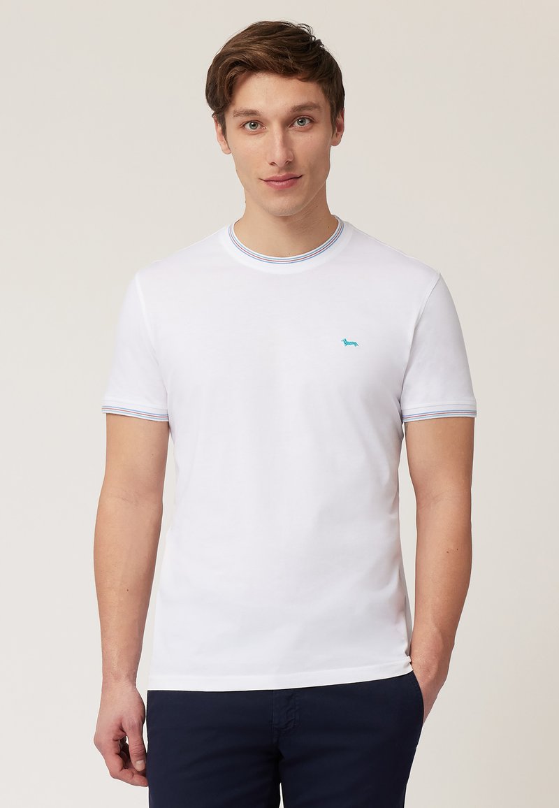 White cotton T-shirt with short sleeves, round neck, and a blue embroidered logo on the chest. Features subtle striped accents on the collar and cuffs.