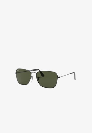 Occhiali da sole Ray-Ban con montatura in metallo nera, lenti verdi e forma geometrica, dotati di aste sottili e naselli regolabili.