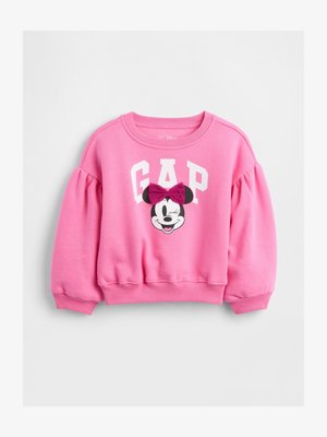 Rozā bērnu sporta krekls ar uzpūstām piedurknēm, baltām "GAP" burtiem un mirkstošu Minijas Peles seju ar tumši rozā loki priekšpusē.