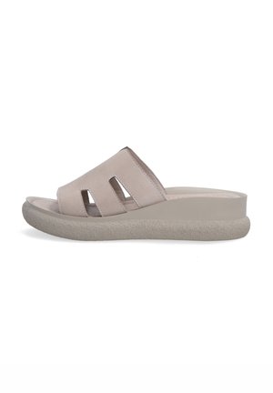 Light beige slide sandal with three cut-out openings, a cushioned sole, and a textured, slightly raised heel design. Smooth leather upper.