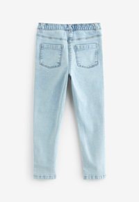 Svetlo modré džínsy s elastickým pásom, dvoma zadnými vreckami a slim fit strihom. Hladký povrch s jemne vyblednutým vzhľadom.