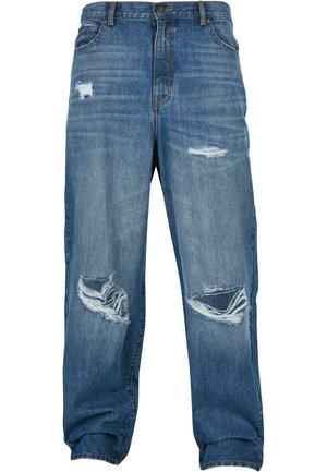 Falmet blå denimjeans med avslappet passform, som har flere slitte lapper og frynsete kanter. Forsterkede lommer og knappelukking.