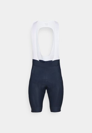Calções de ciclismo tipo bib em azul-marinho e branco. Apresentam um design sem mangas, área de assento almofadada e aberturas elásticas nas pernas para conforto e ajuste.