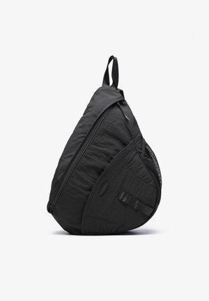 Black backpack with a teardrop shape, made from lightweight fabric, featuring a zip closure, mesh pocket, and adjustable strap.