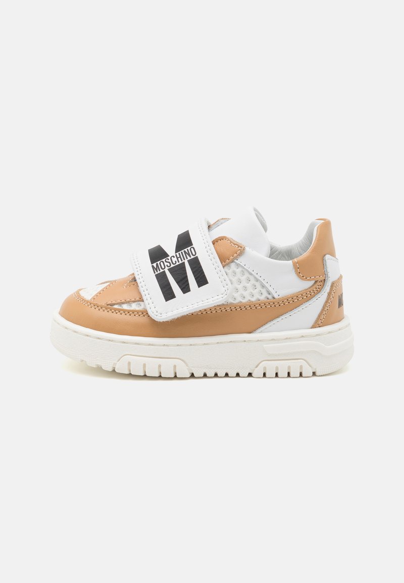 Tan and white sneakers with a textured design, featuring a wide velcro strap adorned with black "MOSCHINO" text and a chunky white sole.