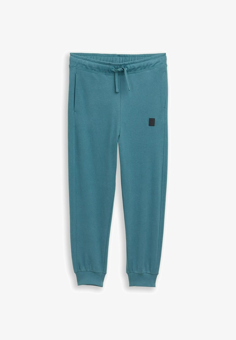 Pantalon de jogging turquoise en tissu doux, doté d'une taille élastique avec cordon de serrage, de poches latérales et de poignets côtelés.