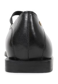 Black leather shoe with a smooth finish, rounded shape, contrasting stitching, flat black sole, and a small metal accent on the side.