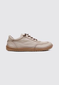 Beige leather sneaker with a textured surface, brown laces, and a rubber sole featuring a subtle tread pattern. Rounded toe design.