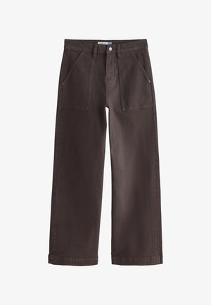 Mørkebrune bukser med vide ben, forlommer foran, bæltestropper og knaplukning på hvid baggrund.