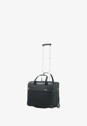 Schwarzer Rollkoffer mit einem ausziehbaren Aluminiumgriff, robustem Stoffkörper, Vordertasche und zwei Rädern für einfache Manövrierbarkeit.