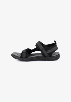 Sandalo sportivo nero con cinturini in Velcro regolabili e suola texturizzata, progettato per comfort e supporto all'aperto.