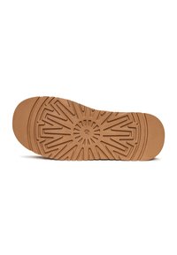 Gummisohlen mit strukturierten, gemusterten Oberflächen. Tanfarbe mit einem zentralen kreisförmigen Design und strahlenden Linien, die nach außen verlaufen.