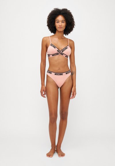 Conjunto de biquíni rosa com um bralette de alças finas e um design cruzado, acentuado com a marca "MOSCHINO" em preto ao longo das bordas.