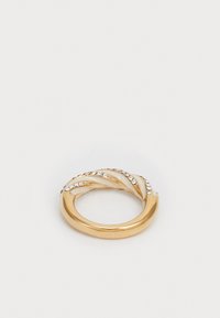 Gold-tone ring with twisted design, featuring white enamel accents and small clear rhinestones along one side. Smooth, glossy finish.
