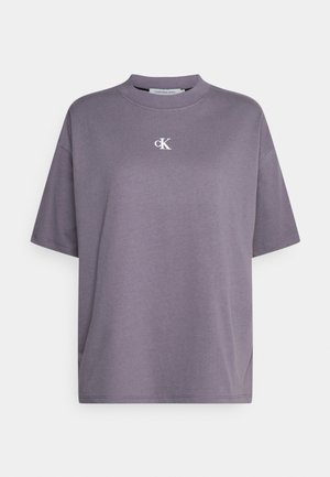 Oversized gray cotton T-shirt with a crew neck and short sleeves, featuring a small white "ck" logo on the chest. Smooth texture.