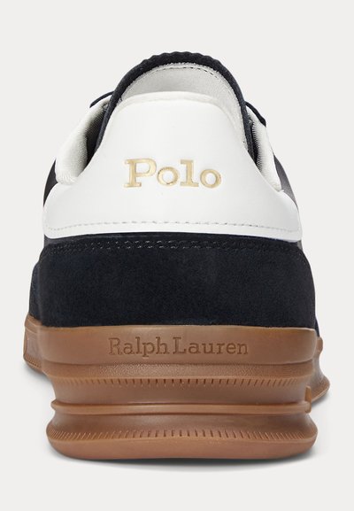 Navy suede and white leather sneaker with gold "Polo" logo and "Ralph Lauren" embossed on the brown rubber sole. Cushioned back design.