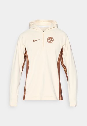 Kremeni dukserica s četvrtim zatvaračem, sadrži smešasti logo i bočne akcentne detalje, glatke teksture, te kontrastne smeđe i zlatne pruge.