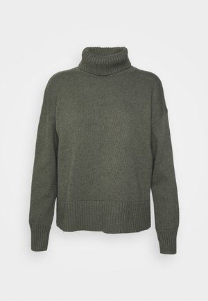 Olive green knitted sweater with a high turtleneck, ribbed cuffs, and hem. Dropped shoulders and relaxed fit create a loose silhouette.